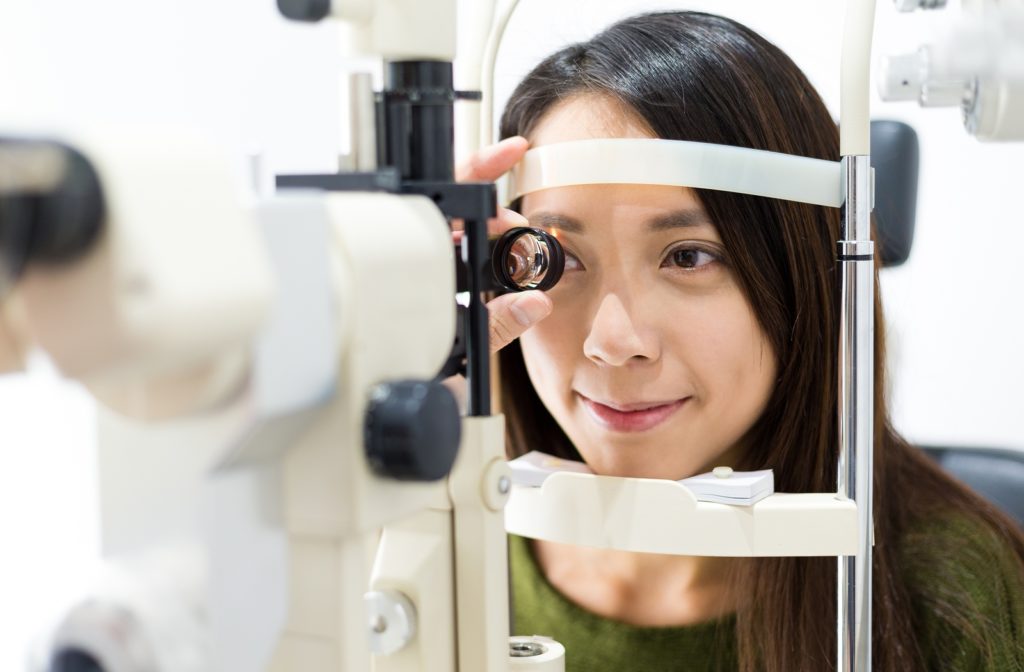 A woman at her optometrist, undergoing an eye exam to ensure overall ocular health