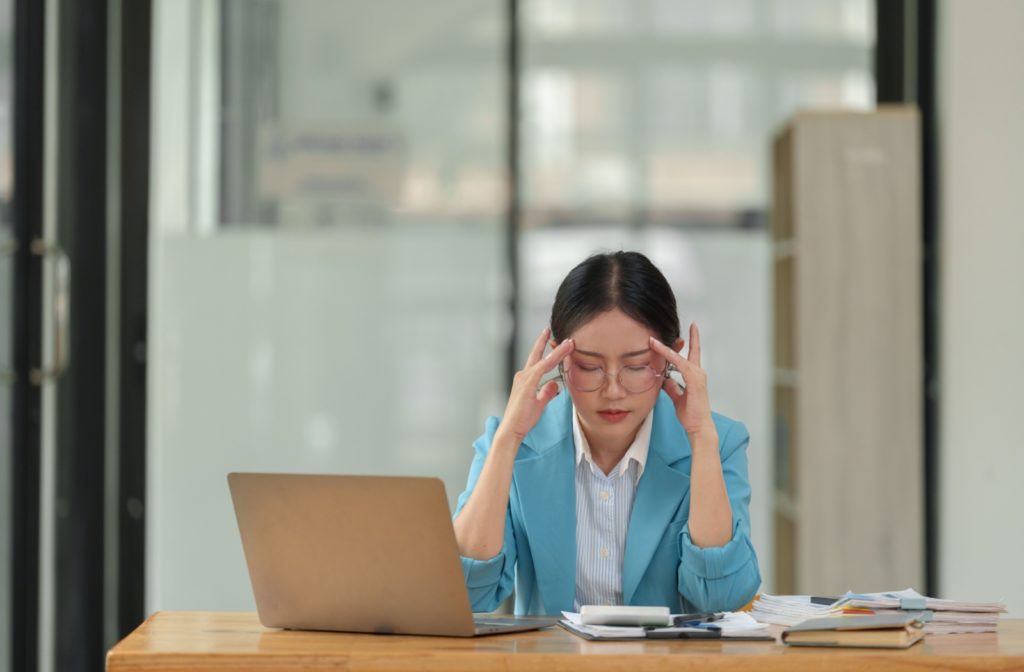 Woman has headache from new glasses purchased online.