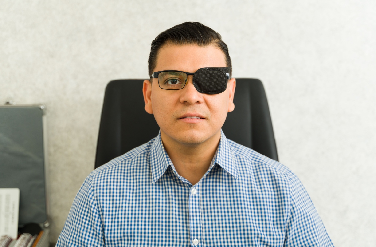 An adult wears an eye patch to treat lazy eye.