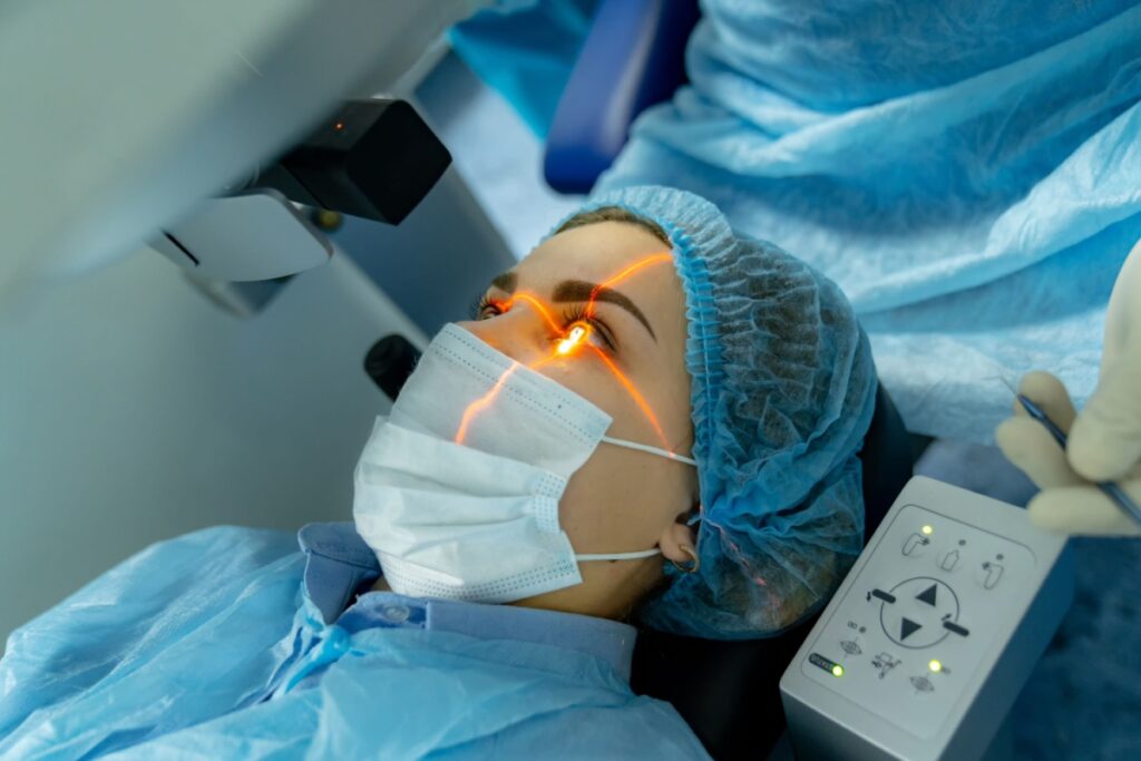 Woman receiving laser eye surgery wearing surgical gown